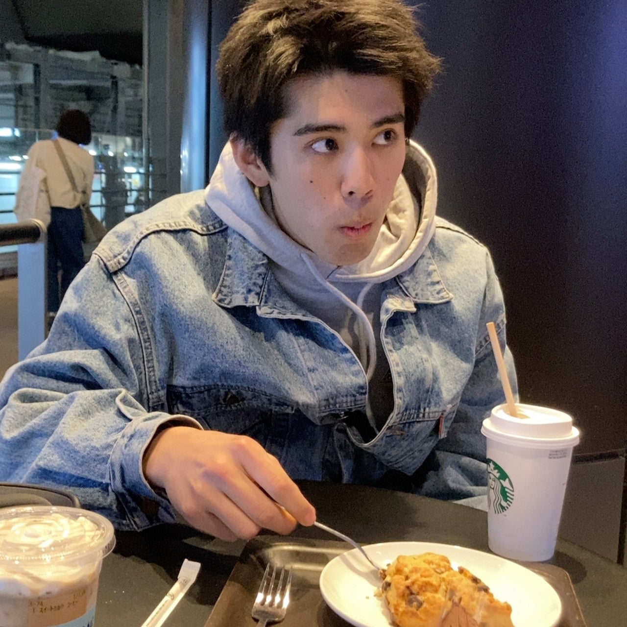 Kotaro Inai eating scones at Starbucks