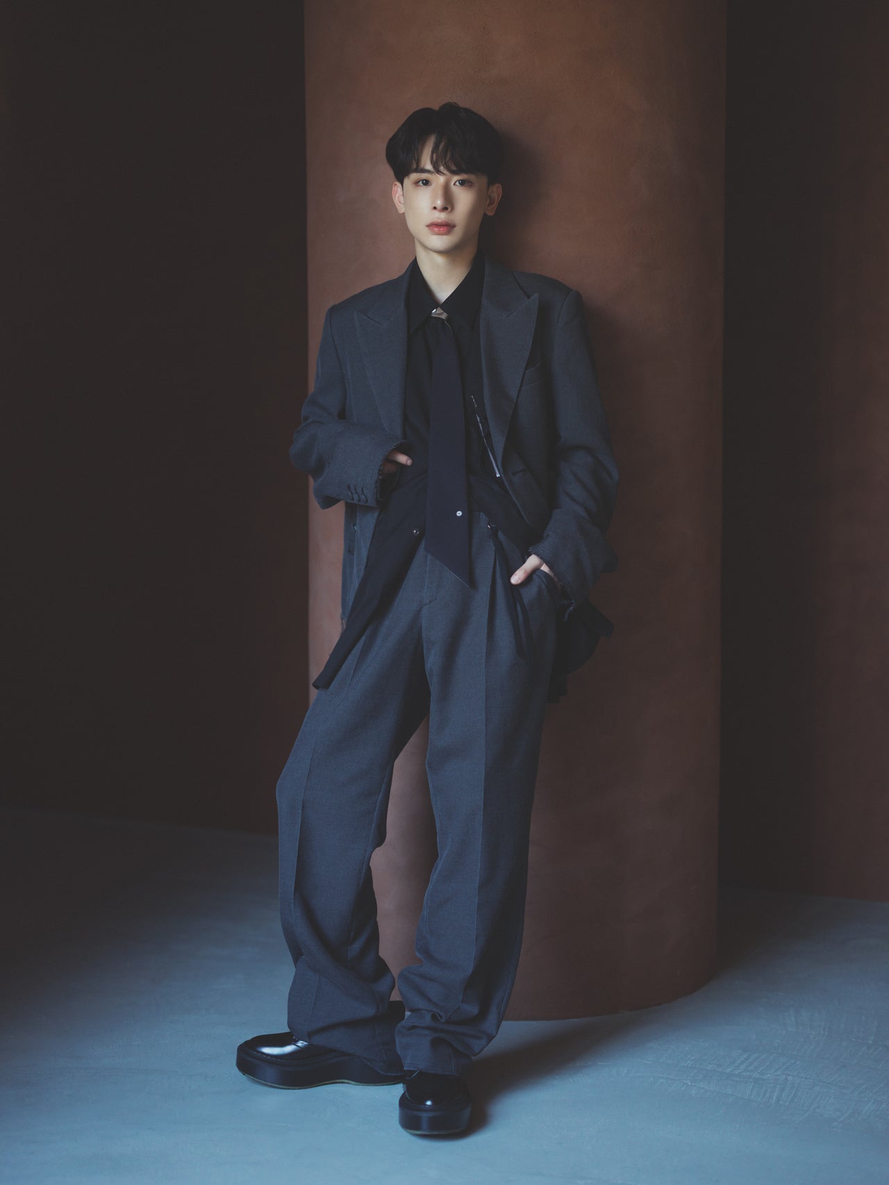 グレーのセットアップを着たよしあきさんの全身コーディネート