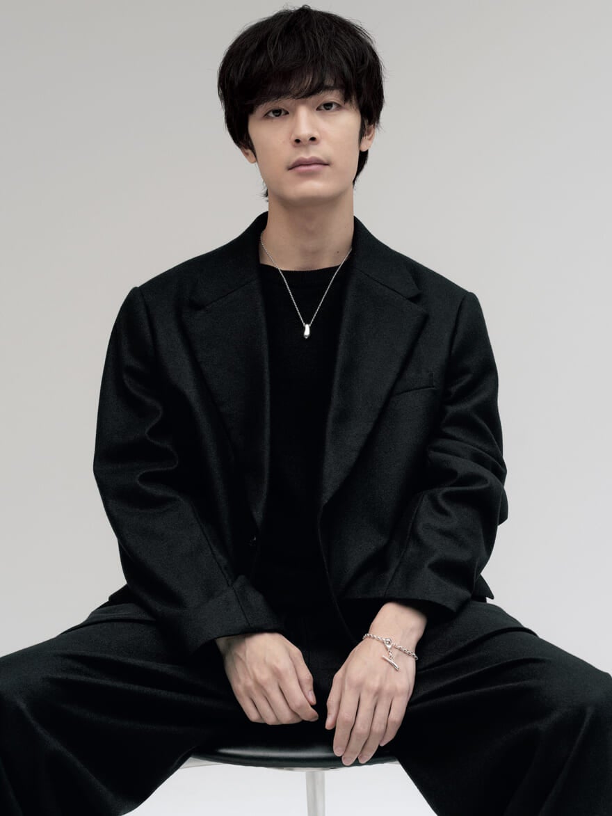 ete(エテ)の2025年秋冬の新作チェーンネックレスを着用する俳優の塩野瑛久さん 黒いテーラードジャケットにコーディネート