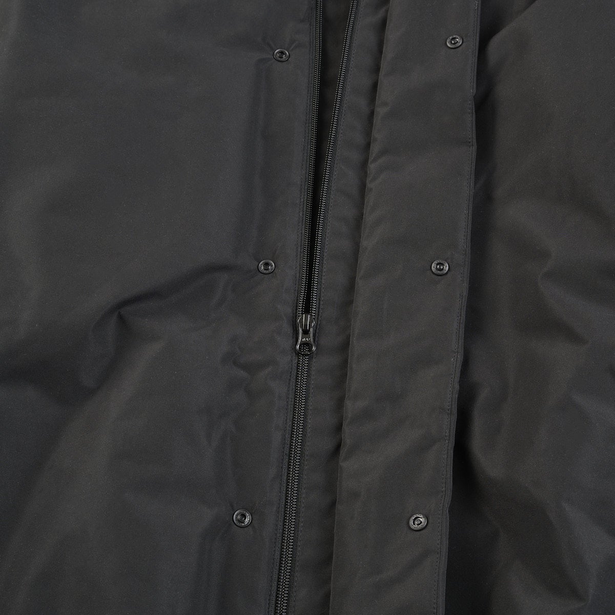 無印良品の黒い紳士 防風撥水中わたフードジャケットのジップ
