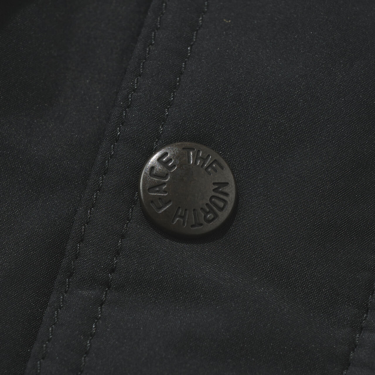 ザ・ノース・フェイスの黒い中綿ジャケット/マウンテンインサレーションジャケットのボタン