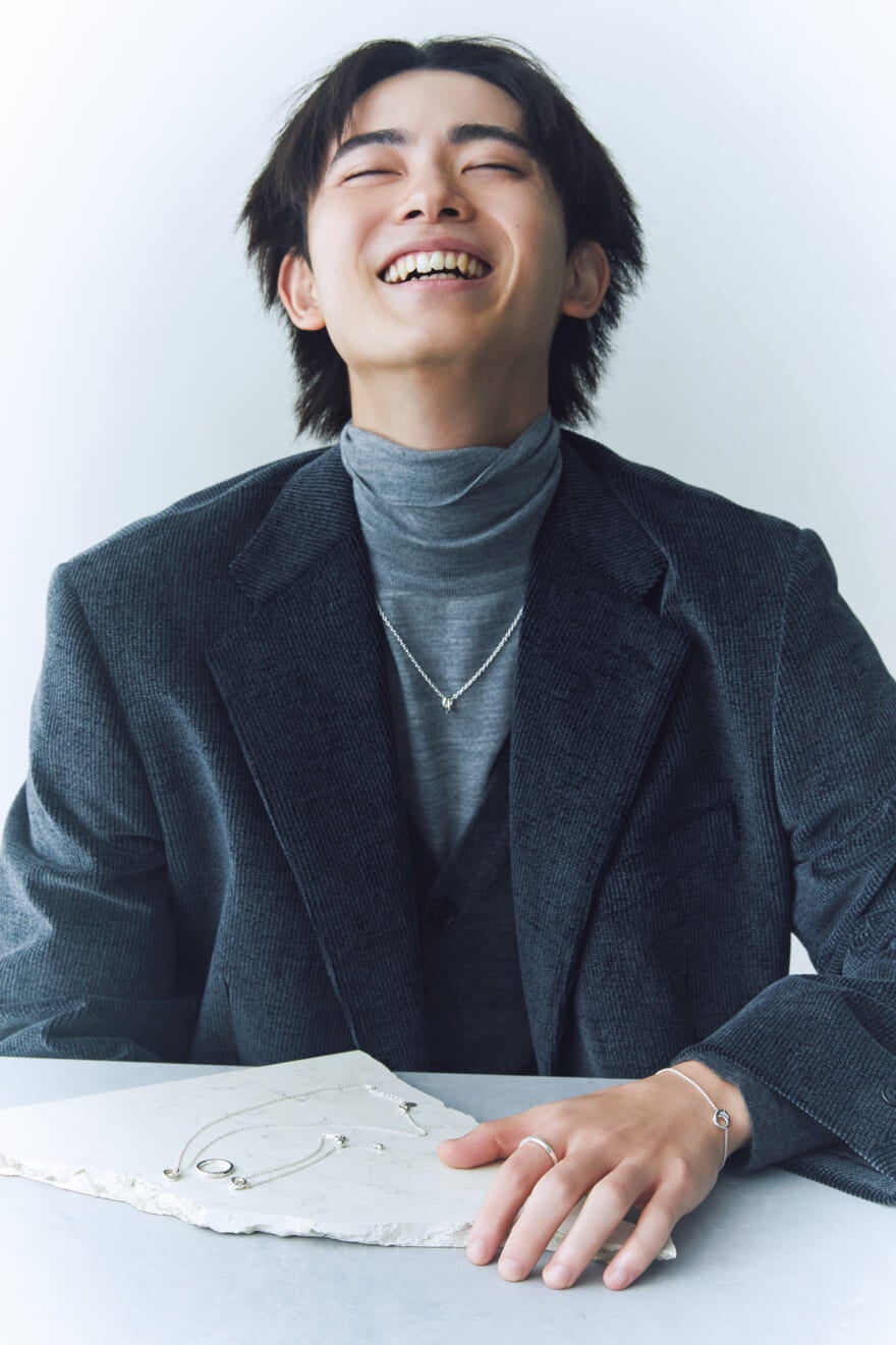 4℃のペアジュエリーを身につける笑顔の豊田裕大さん