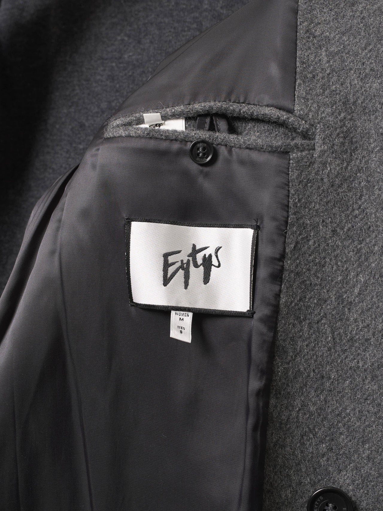 エイティーズのコートのタグ