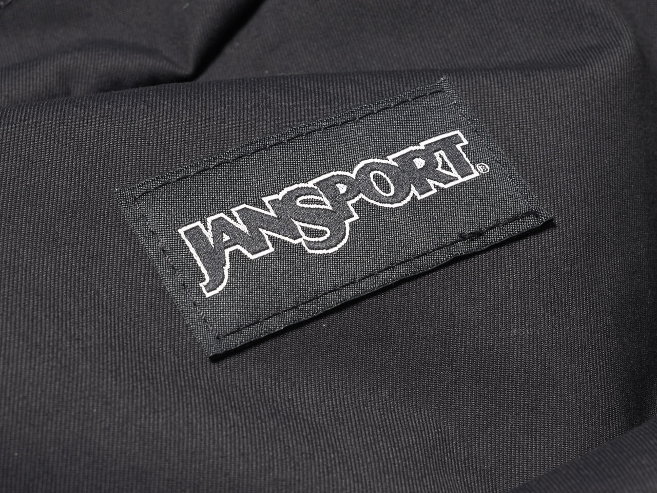 収納力も後ろ姿も抜かりない。大人が持てる毎日にちょうどいい「ジャンスポーツ」の黒バックパック。[JANSPORT］