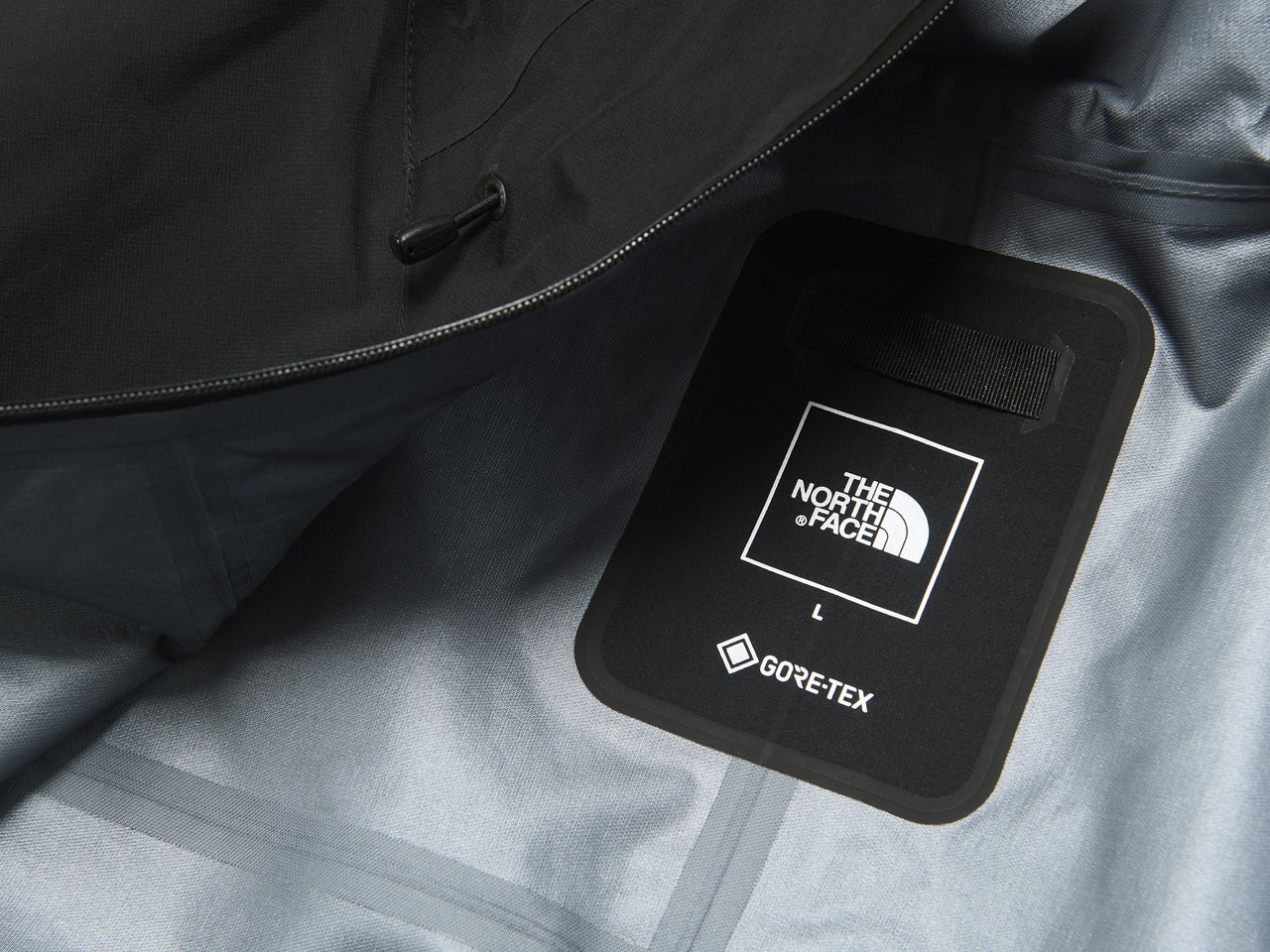 ザ・ノース・フェイスの黒いゴアテックスジャケット／クライムライトジャケットのロゴ寄り