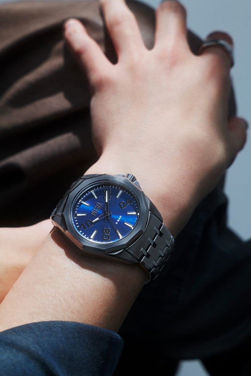 DIESEL（ディーゼル）のメンズ腕時計「STINGER」のガンメタル&times;ブルーを着用する豊田裕大さんの手もと