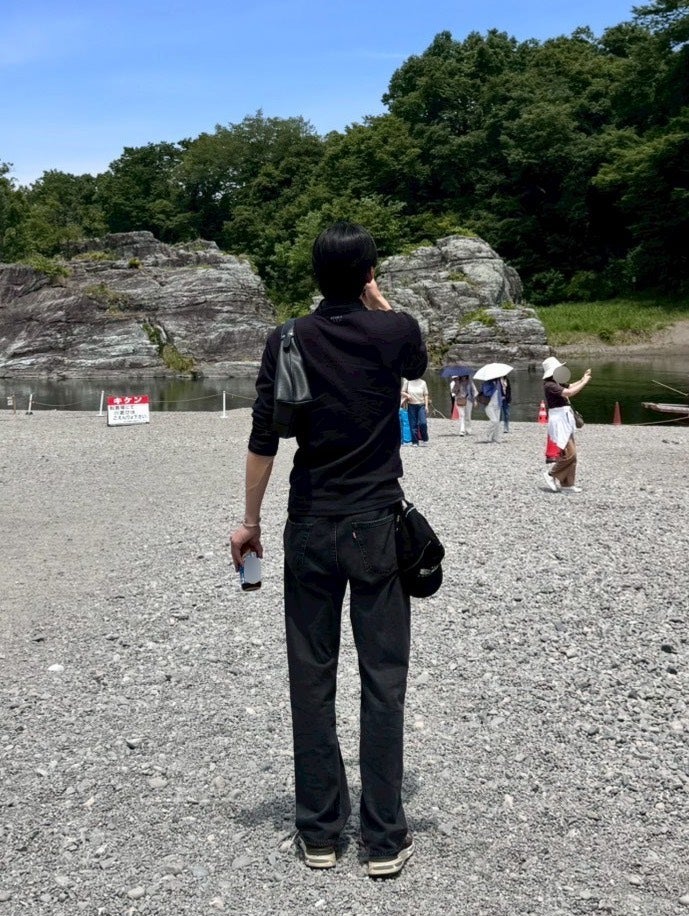 河原にいる石川愛大の後ろ姿。